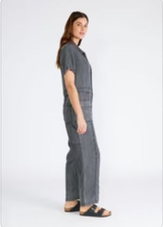 A classic utility-style jumpsuit in an ash grey wash tencel. Tencel Relaxed fit Short sleeve Long straight leg Collared neckline Button front top Zip fly closure Front patch pockets Back patch pocket Utility jumpsuit A jumpsuit to wear on repeat all spring and summer long. Featuring the perfect relaxed fit, our utility-style one-piece is crafted from lightweight tencel and features a button-front top and collared neckline. Short sleeves keep things breezy, while the straight long leg pairs well Utility Jumpsuit, Hair Socks, Style Jumpsuit, Casual Bodysuit, Sparkle Top, Pearl Accessories, Utility Style, Overalls Pants, Baby Pajamas