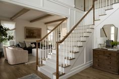 a living room filled with furniture and a stair case