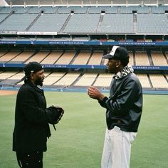 two men standing on a baseball field talking to each other