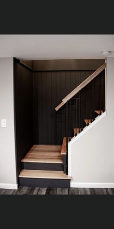 an empty room with stairs leading up to the second floor