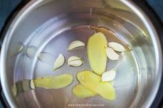 peeled apples in a silver bowl with water