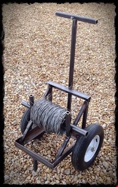 an old fashioned hand truck made out of wire and wood with wheels on the ground