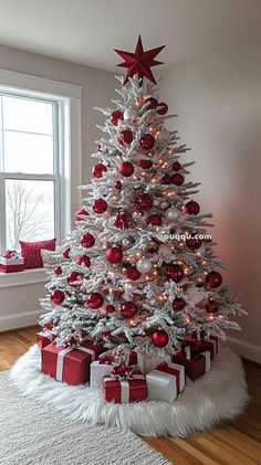 a white christmas tree with red and silver ornaments