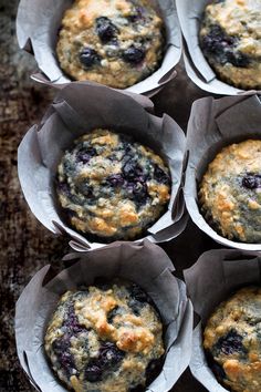 blueberry muffins in paper cups on a table