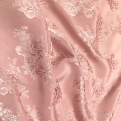 an image of a pink fabric with floral design on the top and bottom half of it