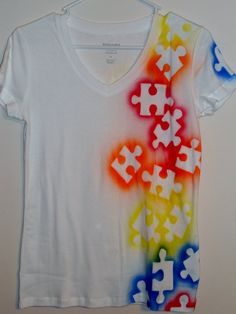 a white t - shirt with puzzle pieces on it