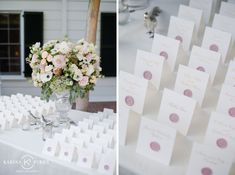 the table is set up with place cards and flowers in vases on top of it