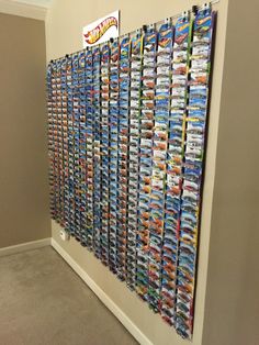 there is a wall with many movies on it in the hallway next to a carpeted floor