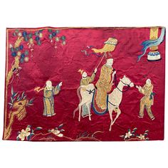 an embroidered red cloth with two men riding horses and one holding a flag in the air