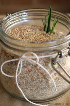 a glass jar filled with sand and grass