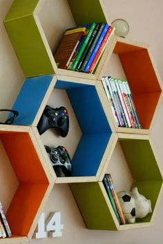 a hexagonal shelving unit with video game controllers and bookshelves on it