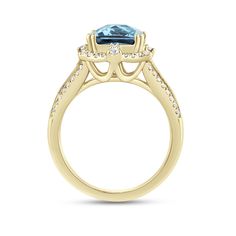 a rose gold engagement ring with an aqua blue topazte and diamonds on the side