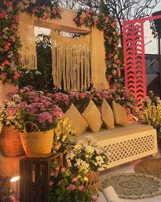 an outdoor seating area with flowers and plants