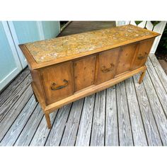 an old wooden chest on a porch