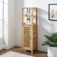 a wooden shelf with some plants on top and a potted plant next to it