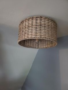 a wicker lamp shade hanging from the ceiling