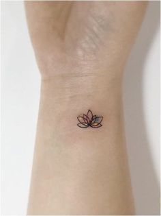 a small lotus tattoo on the wrist