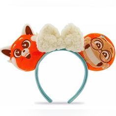 an orange and white headband with two cartoon animals on it's ears,