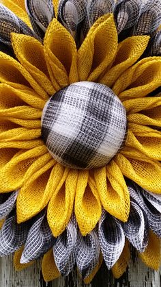 a close up of a sunflower on a wooden surface