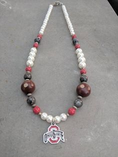 the necklace is adorned with beads and a charm that says ohio on it's side