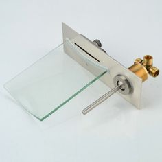 a glass and brass faucet on a white background with no one around it