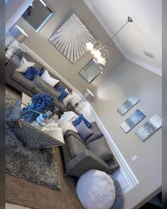 an aerial view of a living room with couches, tables and pictures on the wall