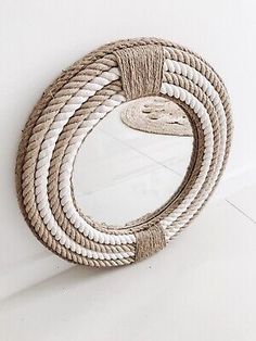 a rope mirror hanging on the wall