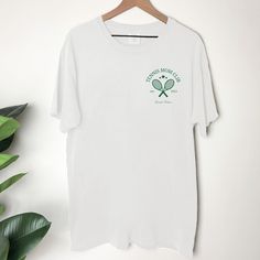 Discover the perfect blend of style and passion with our Tennis T-shirt - a wonderful choice for tennis lovers and an ideal gift for the women who ace every match in life. Whether you're seeking to surprise a tennis-loving mom or impress a friend who dominates the court, this tee is designed to serve up both comfort and style. Crafted with care, this Tennis T-shirt is more than just an apparel piece; it's a symbol of dedication to the game. The impeccable design captures the essence of tennis culture, making it an exceptional choice for country club gatherings or casual outings. Let the world know about your love for the sport with every wear. Looking to hit a winner with your gift choice? Look no further! Our Tennis Shirt Gift is tailored for tennis enthusiasts and casual players alike. T Tennis Shirt, Tennis Shirts Designs, Tennis Tshirts, Tennis Gifts, Tennis Shirts, Team Shirts, Dye T Shirt, Mens Fashion Casual, Tennis