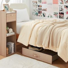 a bedroom with a bed, dresser and pictures on the wall