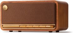 an old fashioned wooden radio is shown on a white background with gold trimmings