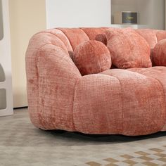 an orange couch sitting on top of a checkered floor