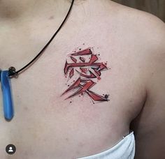 a woman with a tattoo on her chest has the word love written in red ink