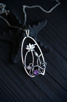 The size H 4 cm x W 3 cm (1 3/4 x 1 inch). Weight - 6g. You can buy it with the chain or without. The most delicate flower of the lotus can make someone very happy. I made this botanical jewelry of sterling silver, amethyst, and peach moonstone. This is a true work of art. It will emphasize your exquisite taste and status, and will also bring a lot of compliments. Lotus flower earrings https://www.etsy.com/listing/676137548/lotus-flower-earrings-sterling-silver?ref=shop_home_active_2&frs=1 O Purple Amulet Jewelry As Gift, Handmade Artistic Jewelry For Meditation, Purple Amulet Style Jewelry Gift, Purple Amulet Jewelry As A Gift, Wire Wrapped Flower Pendant Jewelry Gift, Handmade Teardrop Pendant Jewelry For Wedding, Nature-inspired Sterling Silver Jewelry For Meditation, Handmade Spiritual Jewelry With Flower Pendant, Amethyst Large Pendant Jewelry Gift