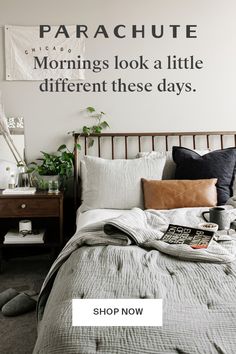 a bed room with a neatly made bed and a poster on the wall that says, parachute mornings look a little different these days