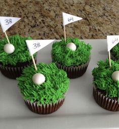 cupcakes decorated with green grass and white golf flags