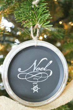 a chalkboard ornament hanging from a christmas tree