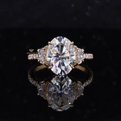 an oval cut diamond ring with side stones