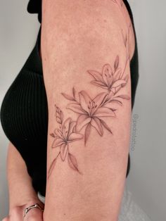 a woman with a flower tattoo on her arm