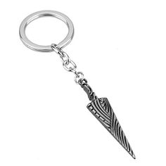 a metal keychain with an arrow on the front and back ends, hanging from a