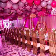 a long table with many chairs and balloons