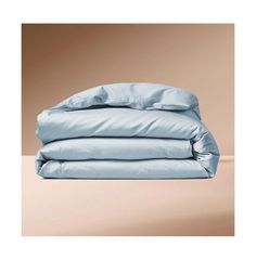 two blue sheets stacked on top of each other in front of a beige wall and floor