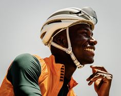 a man wearing a helmet and holding his hand up to his mouth