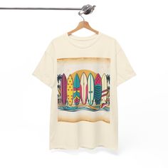 This Unisex Heavy Cotton Tee features a vintage-inspired graphic illustration of surfboards, skateboards, and beach scenes, capturing the carefree essence of 1960s and 1970s surf culture. Perfect for those who love retro vibes and enjoy a laid-back style, this tee is ideal for beachgoers, surf enthusiasts, and anyone who appreciates nostalgia. Great for summer, beach vacations, surf-themed parties, or casual outings. Product features - Shoulder tape for stability and prevent stretching - Knitted in one piece without side seams to reduce fabric waste - Ribbed knit collar without seam for elasticity and shape retention - Made from specially spun fibers for strong and smooth fabric, suitable for printing - Certified by Oeko-Tex for safety and quality assurance Care instructions - Machine wash Beach Skateboard, Retro Surfboard, Surfing Lifestyle, Vintage Surfing, Surf Vintage, Summer Ocean, Surf Culture, Surf Lifestyle, Vintage Surf