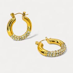 Elevate your style with these stunning circular rhinestone hoops. Featuring a chic design crafted from durable stainless steel and luxuriously plated in 18K gold, these earrings are the perfect blend of elegance and contemporary fashion. The intricate inlaid rhinestones add a captivating sparkle, making them an essential accessory for any fashionista. Hypoallergenic and water-resistant, these hoops promise both beauty and comfort. Make a statement and enhance any outfit with this exquisite addit Rhinestone Earrings, Gorgeous Earrings, Contemporary Fashion, Chic Design, Gold Plating, Design Crafts, Jewelry Collection, 18k Gold, Gold Plate