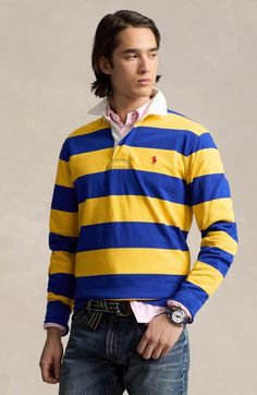 "Find RALPH LAUREN Stripe Cotton Rugby Shirt on Editorialist. Your rough-and-tumble side is in evidence in this boldly striped rugby shirt made from heavyweight cotton with a traditional twill placket and rubber buttons. 29 1/2\" length (size Medium) Button half placket Spread collar Long sleeves with ribbed cuffs Side slits 100% cotton Machine wash, dry flat Imported" Cotton Polo Sweater With Striped Collar, Striped Cotton Polo Sweater, Classic Long Sleeve Polo Shirt With Contrast Stripes, Striped Long Sleeve Polo Shirt, Cotton Long Sleeve Polo Shirt With Contrast Stripes, Cotton Polo Sweater With Contrast Stripes, Yellow Long Sleeve Cotton Polo Shirt, Ralph Lauren Striped Long Sleeve Tops, Rugby Vintage