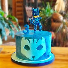 a blue cake with an image of a cat on top