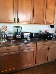 a kitchen with wooden cabinets and appliances on the counter