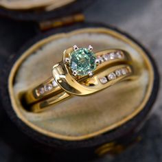 a close up of a ring in a box with diamonds on it's sides