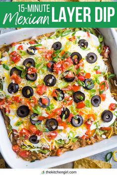 image of seven layer dip in square white dish with scattered tortilla chips. Title text: 15-minute Mexican Layer Dip Mexican 7 Layer Salad, Mexican 7 Layer Dip Easy, Mexican Layer Dip Recipe Easy, 7 Layer Dip No Guacamole, Vegetarian 7 Layer Dip, Fiesta Bean Dip, 7 Layer Dip With Meat, 7 Layer Bean Dip Easy, Hot Layered Mexican Dip