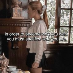 a woman standing in front of a table with food on it and a quote from the movie